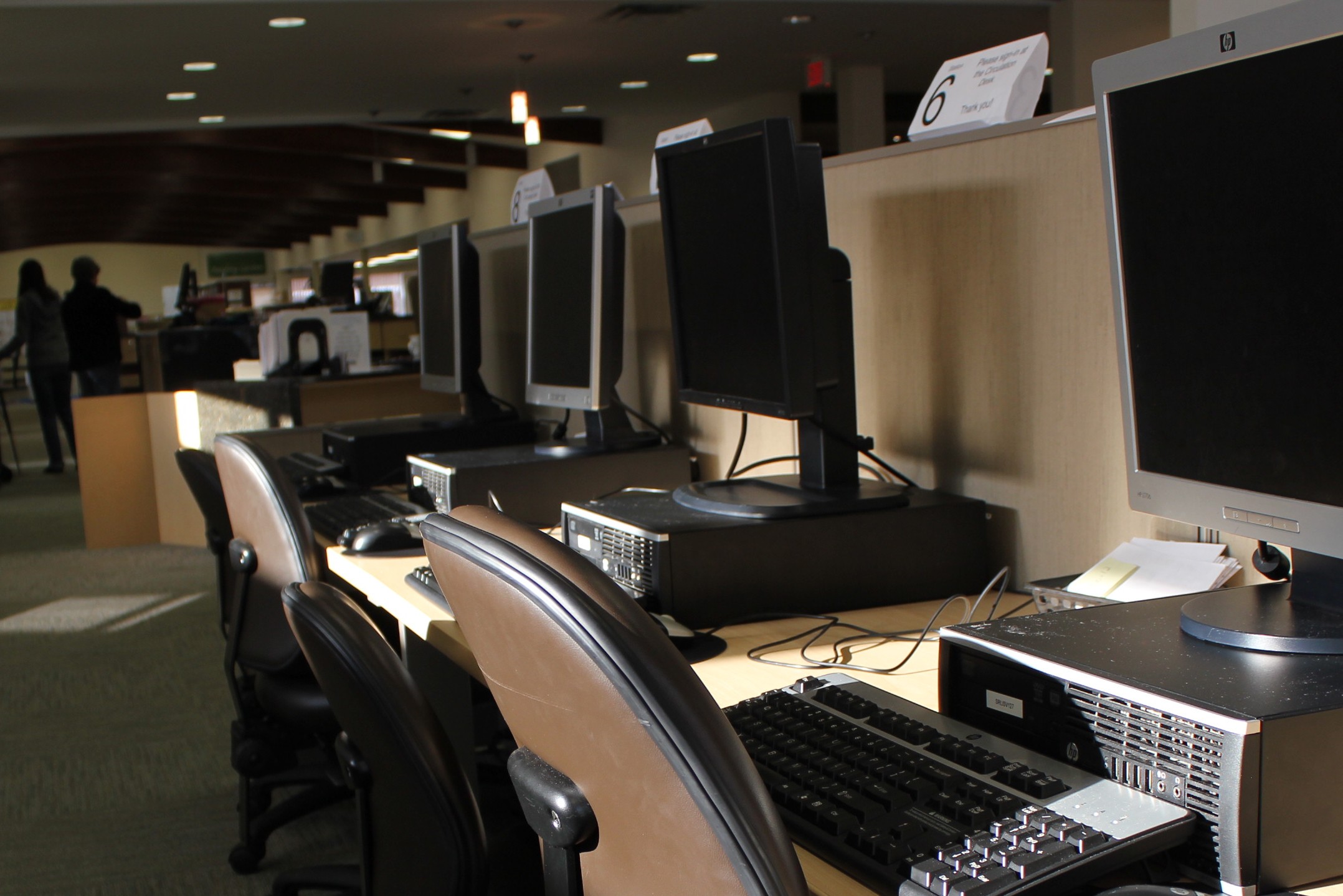 a row of computers on a long desk